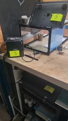 a laptop computer sitting on top of a workbench