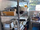 a kitchen with a lot of pots and pans on the shelves