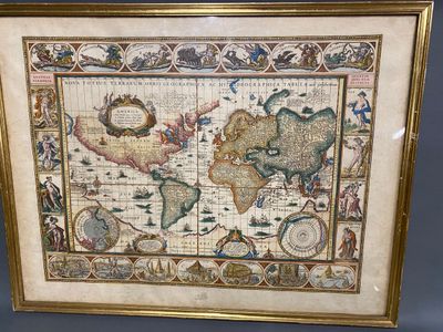 an old map of the world is displayed in a gold frame