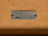 a close up of a sign on the side of a wooden chair