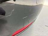 a close up of a car ' s bumper with a red tail light