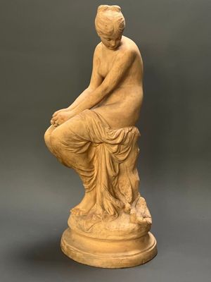 une image représentant une statue d'une femme assise sur un socle