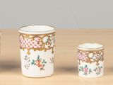 three cups and a container sitting on a table