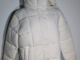 the jacket is white and has a hood that is attached to it