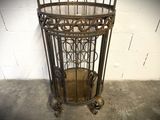 a birdcage with a clock inside of it in a room