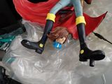 a figurine of a woman sitting on a plastic bag