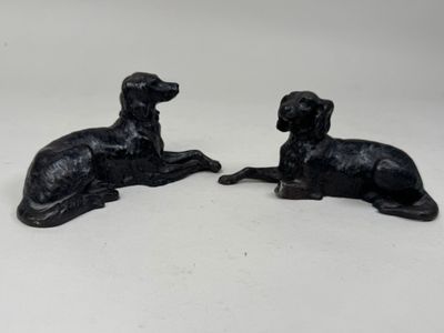 pair of black dog figurines on a white background