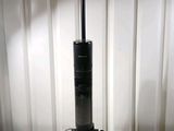 a black vacuum cleaner sitting on a white table
