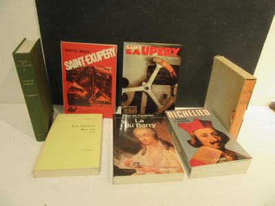 several books are sitting on a table next to each other