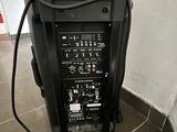 a speaker that is sitting on a stand in a room