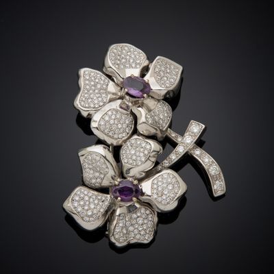 a close up of a brooch with diamonds and a cross