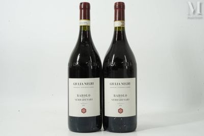 two bottles of red wine sitting next to each other on a white surface