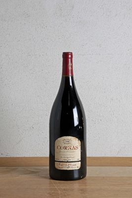 a bottle of wine sitting on a wooden table