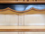 a wooden cabinet with a black and gold trim