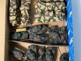 a cardboard box filled with assorted military items