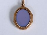 an image of a gold locke with a purple glass in the center