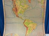 an old map of the americas with a wooden frame on a table