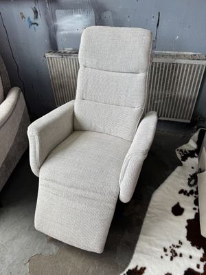 deux fauteuils inclinables dans une pièce où se trouve un tapis en peau de vache