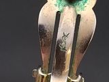 a silver fork with a green flower on it