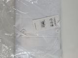 a white shirt wrapped in plastic on a table