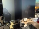 an image of a computer monitor and keyboard on a desk