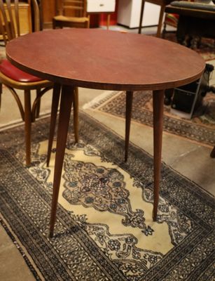 a table with two chairs and a rug on the floor
