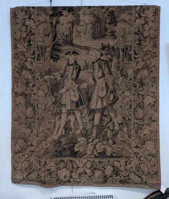 a tapestry hanging on the wall next to a radiator