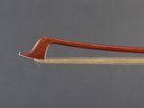 a close up of a bow on a stick with a gray background