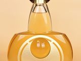 an image of a bottle of perfume on a beige background