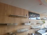 a bar with a lot of bottles and glasses on the wall