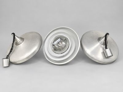 three silver metal lamps on a white background