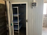 a room with a door and a shelf in it