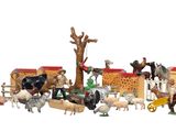 a lot of toy animals that are on a white surface