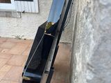 a black piano that is leaning against a wall