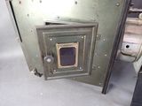 a metal door that has a small window in it