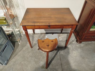 a small wooden table with a stool in front of it