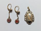 two pairs of earrings and a pendant with a picture of a woman