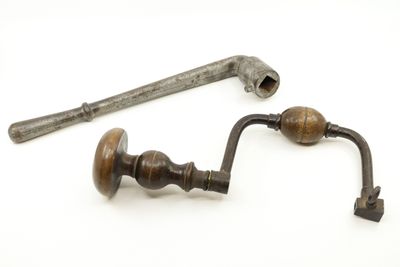 two old tools that are sitting on a white surface