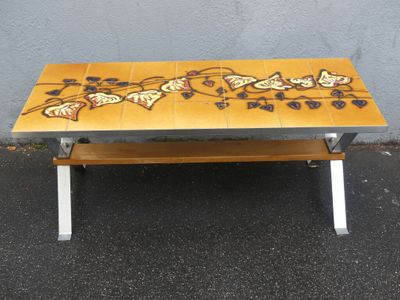 tiled coffee table with butterfly design on top and metal legs