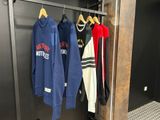 three jackets hanging on a rack in a closet