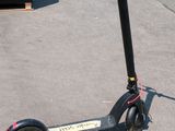 a scooter that is sitting on the sidewalk