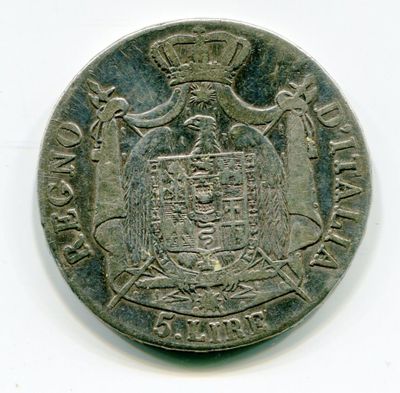 une vieille pièce d'argent sur laquelle figurent des armoiries surmontées d'une couronne