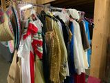 a lot of clothes hanging on a rack in a room