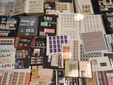 a lot of stamps and stamps on the table