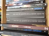 many dvds stacked on top of each other on a shelf