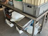 a metal table with a bunch of boxes on top of it