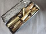 a metal box with a bunch of bullet shells inside of it
