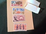 une personne tenant un morceau de papier sur lequel figurent des timbres