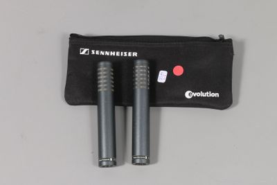 two microphones in a pouch with a zipper on a white surface