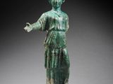 an image of a statue of a woman in a green dress